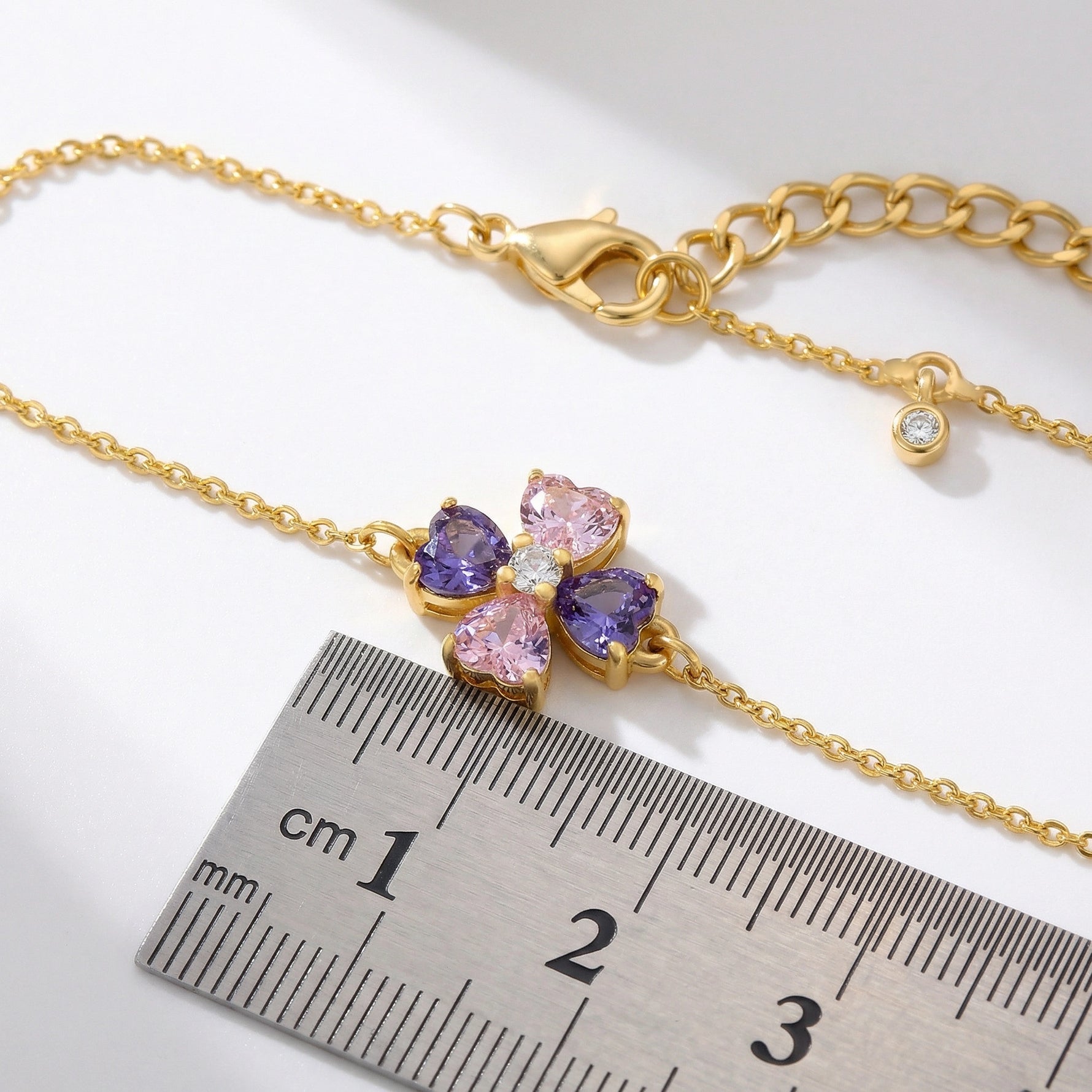 18k Gold plated bracelet with butterfly-shaped gemstones next to a ruler on a white background