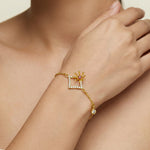 18k Gold plated bracelet with a star and gemstone design on a wrist.