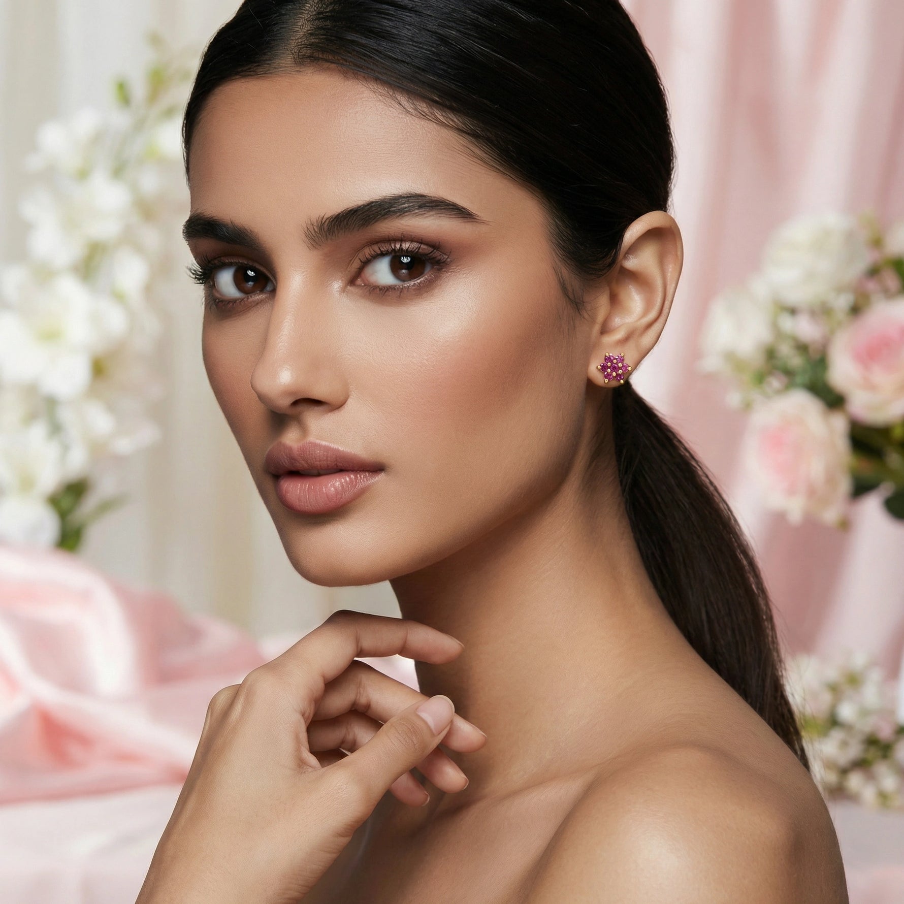 Woman wearing pink 18k gold plated earrings with a floral background