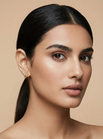 Woman with a sleek ponytail against a beige background