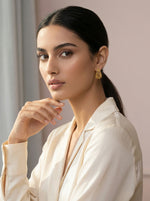Woman wearing a white blouse with a neutral background