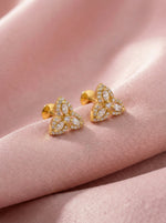 18k Gold plated fearrings with diamond accents on a pink fabric background