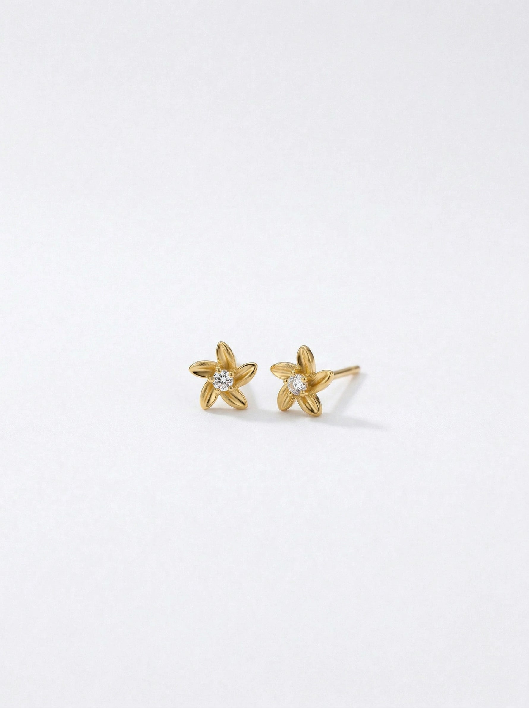 18k Gold plated star-shaped earrings on a white background