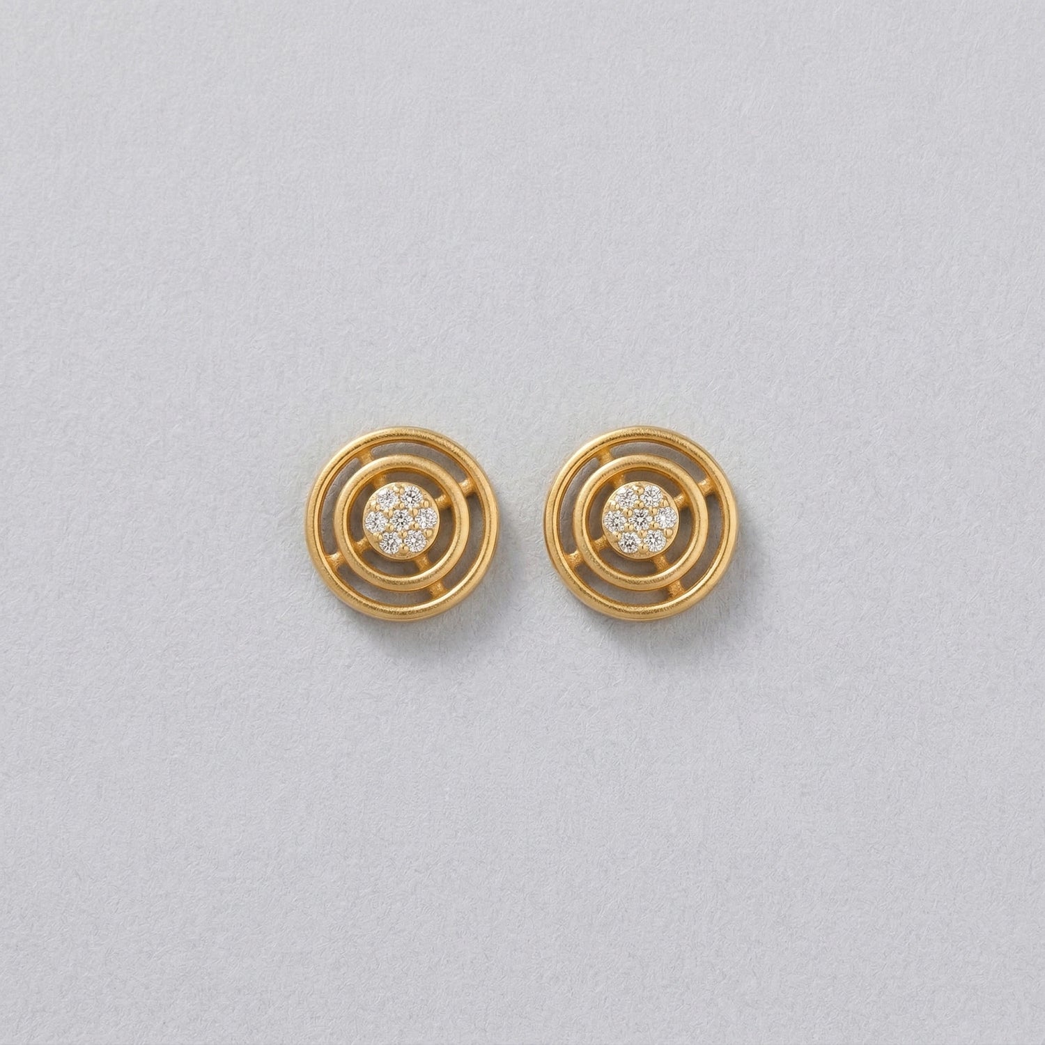 18k Gold plated earrings with circular design on a light gray background