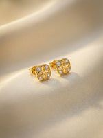 18k Gold plated earrings with diamond accents on a beige background