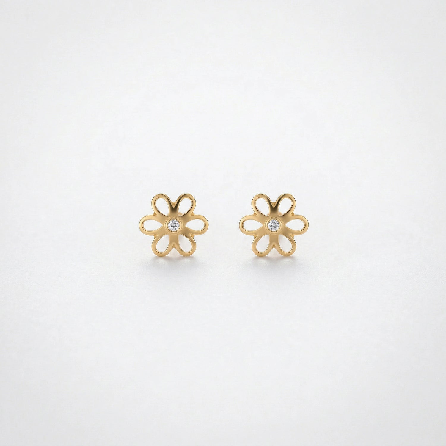 18k Gold plated flower-shaped earrings on a light gray background